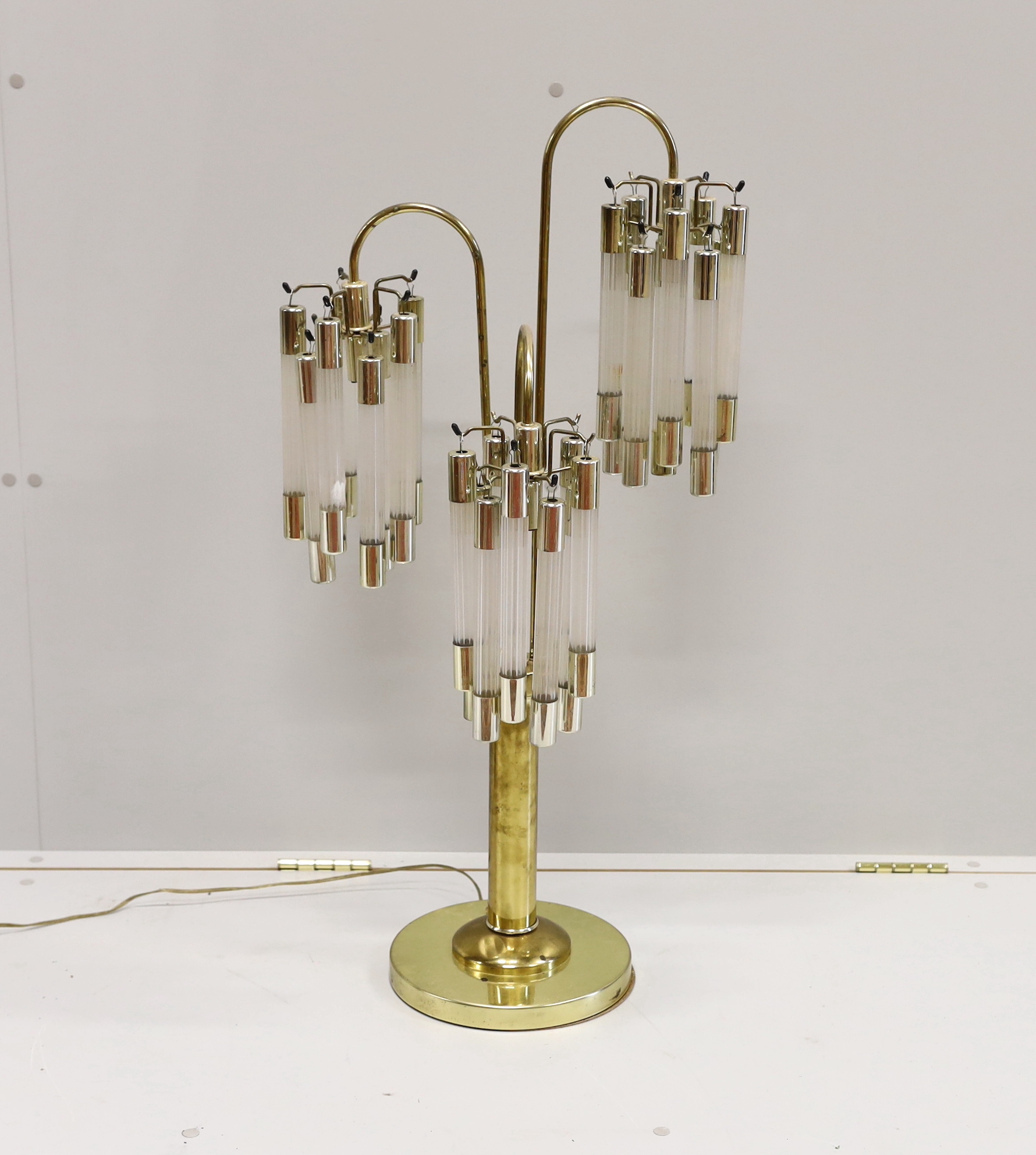 A contemporary brass and perspex three branch table lamp, height 91cm